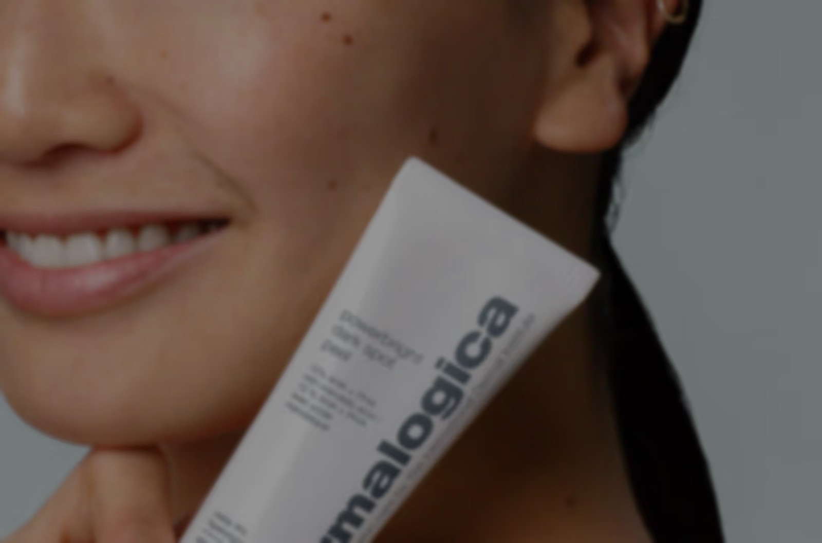 A Skinmart customer holding a Dermalogica product
